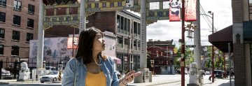 UBC alumna Ernielly Leo uses an augmented reality app to tour Vancouver's historic Chinatown neighbourhood. Developed by UBC professor Siobhán McPhee and students, the app is a historical walking tour that uses geolocation and audio files to enhance a user's experience. (Photo by Abigail Saxton)